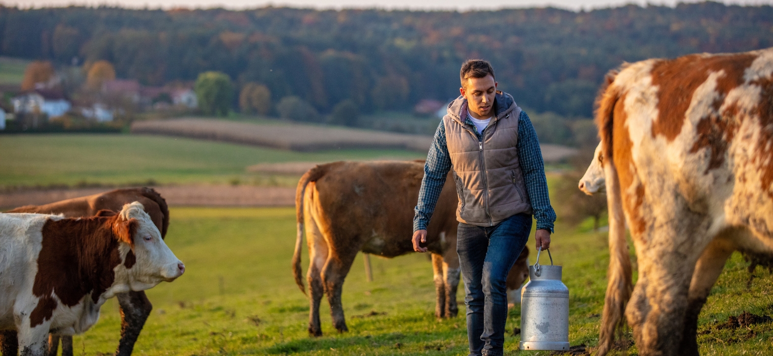 Young man walking with milk canister in his hand